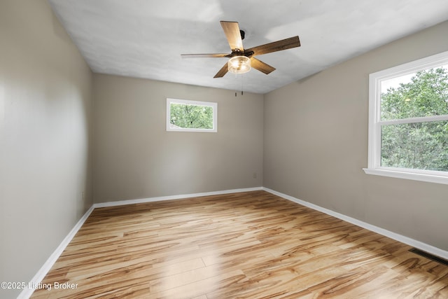 unfurnished room featuring light wood finished floors, baseboards, and a ceiling fan