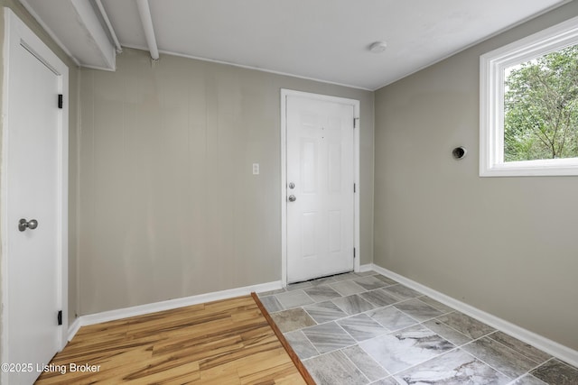 doorway to outside featuring baseboards