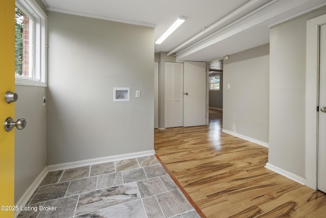 laundry room featuring healthy amount of natural light, hookup for an electric dryer, and baseboards