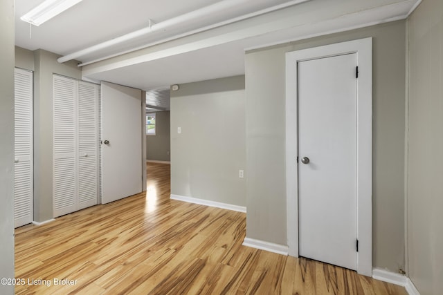 below grade area with wood finished floors and baseboards