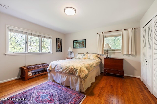 12715 Westport Rd, Louisville, KY 40245 - bedroom featuring multiple windows, wood finished floors, baseboards, and a closet