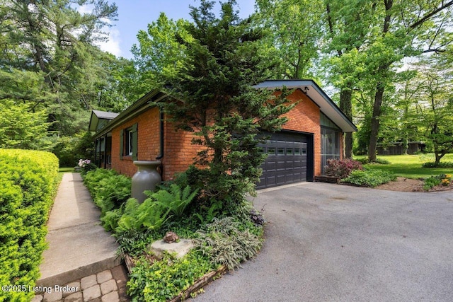 12715 Westport Rd, Louisville, KY 40245 - view of property exterior with brick siding, driveway, and a garage