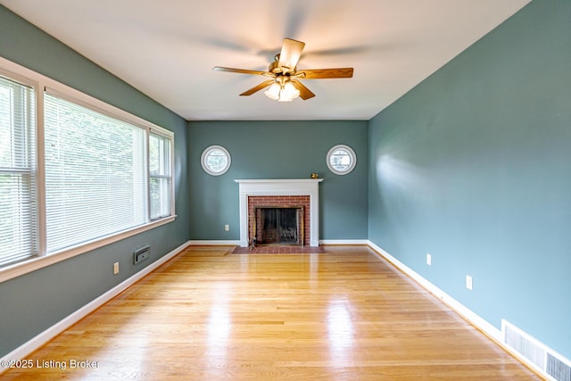 4305 Darbrook Rd, Louisville, KY 40207 - unfurnished living room featuring a ceiling fan, a fireplace, and light wood-style floors