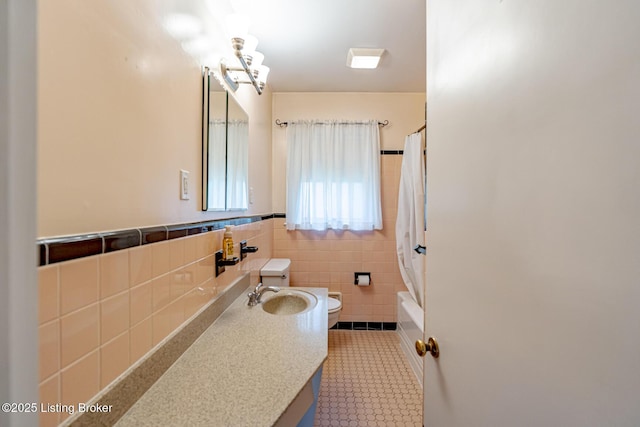 4305 Darbrook Rd, Louisville, KY 40207 - full bathroom featuring tile walls, vanity, wainscoting, shower / tub combo, and tile patterned flooring