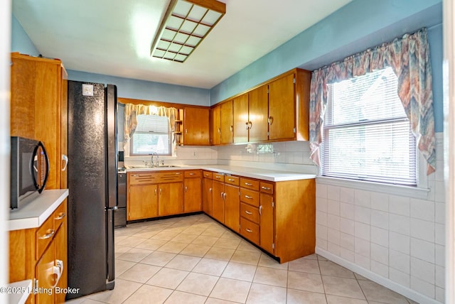 4305 Darbrook Rd, Louisville, KY 40207 - kitchen with brown cabinets, light countertops, and healthy amount of natural light