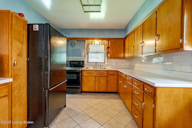 4305 Darbrook Rd, Louisville, KY 40207 - kitchen with black appliances, light tile patterned floors, brown cabinetry, light countertops, and backsplash