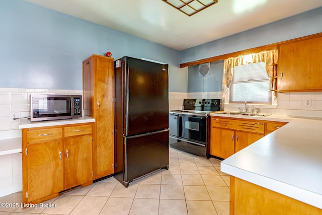 4305 Darbrook Rd, Louisville, KY 40207 - kitchen featuring black appliances, light countertops, tasteful backsplash, and brown cabinets