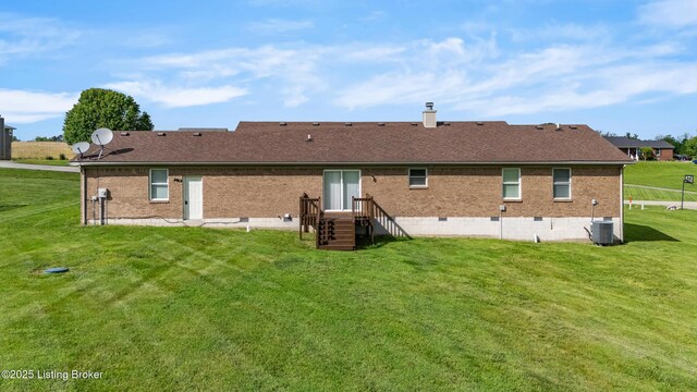 back of property featuring brick siding, a yard, crawl space, and cooling unit