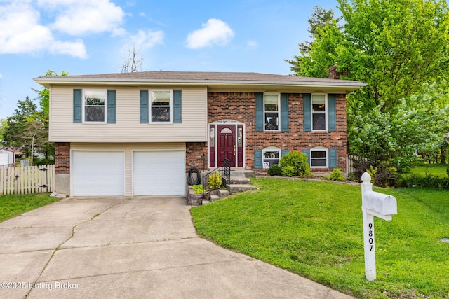 split foyer home with an attached garage, concrete driveway, and brick siding