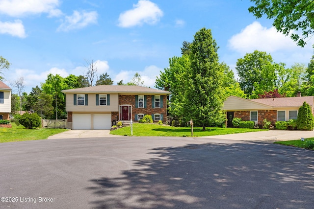 bi-level home with concrete driveway, brick siding, and an attached garage