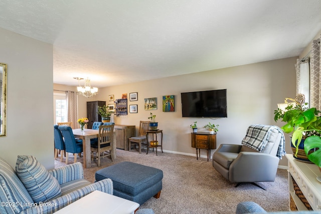 carpeted living area with a chandelier and baseboards