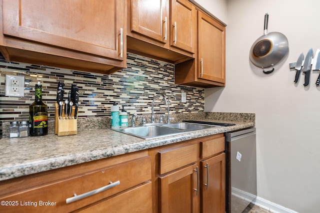 kitchen featuring stainless steel dishwasher, a sink, tasteful backsplash, and brown cabinetry