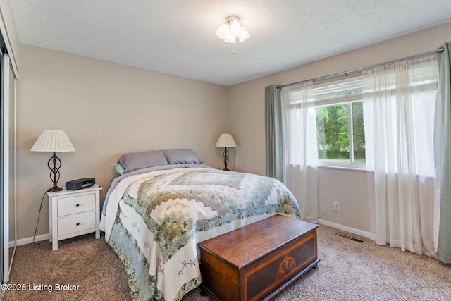 bedroom with carpet floors and baseboards