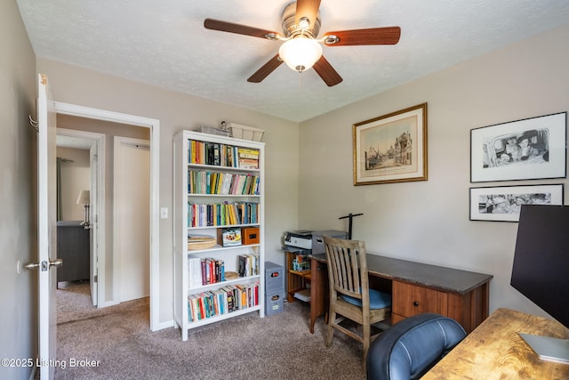 office space featuring carpet floors, ceiling fan, and a textured ceiling