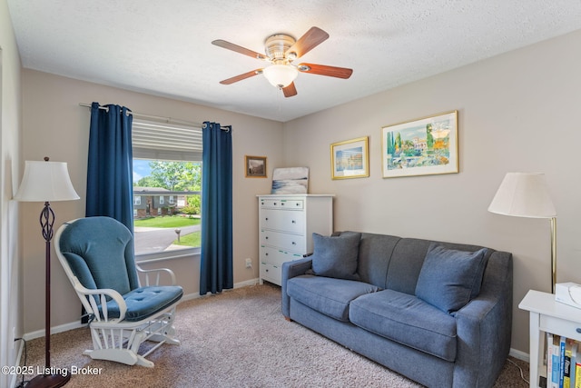 living room featuring carpet floors, a ceiling fan, and baseboards