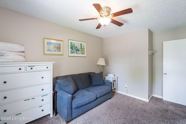 carpeted living area featuring ceiling fan, baseboards, and a textured ceiling