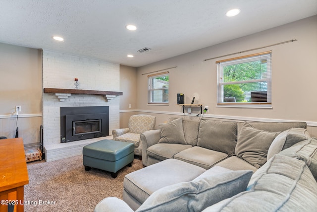 carpeted living room featuring recessed lighting and a fireplace