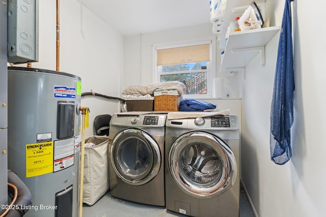 washroom with water heater and washer and clothes dryer