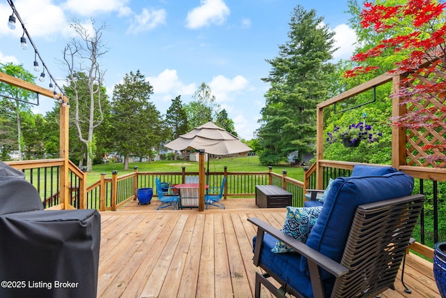 wooden terrace featuring a yard