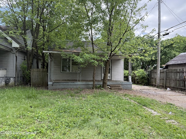 back of house with a porch and fence