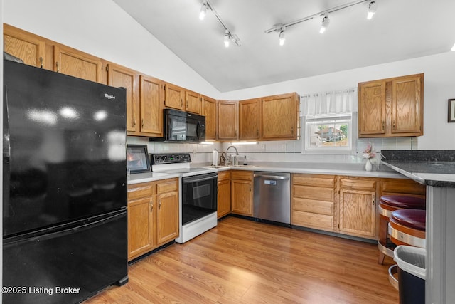 462 Wilsonville Rd, Fisherville, KY 40023 - kitchen with black appliances, lofted ceiling, a sink, rail lighting, and light wood-type flooring