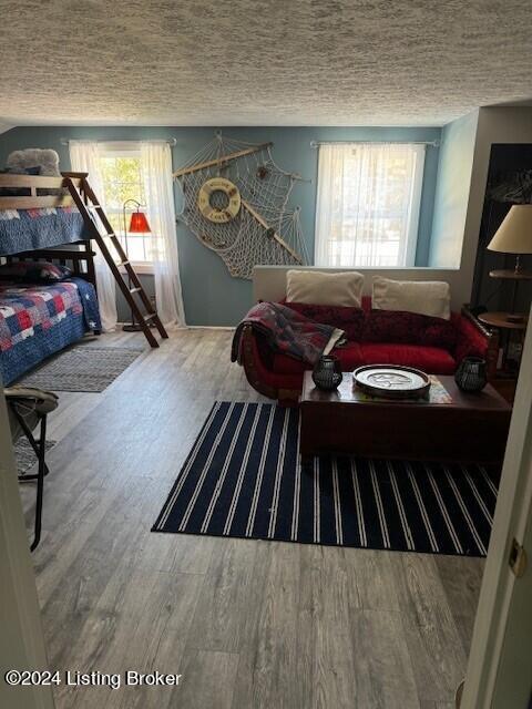 116 Spring Meadow Cir, Campbellsville, KY 42718 - bedroom featuring a textured ceiling and wood finished floors