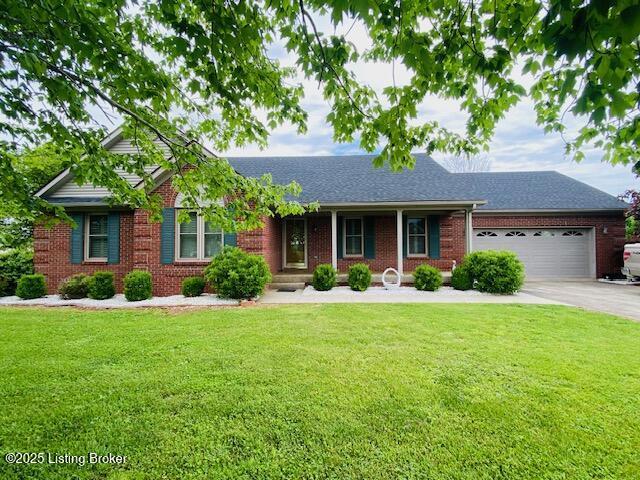 ranch-style home with a garage, brick siding, concrete driveway, a front lawn, and a shingled roof