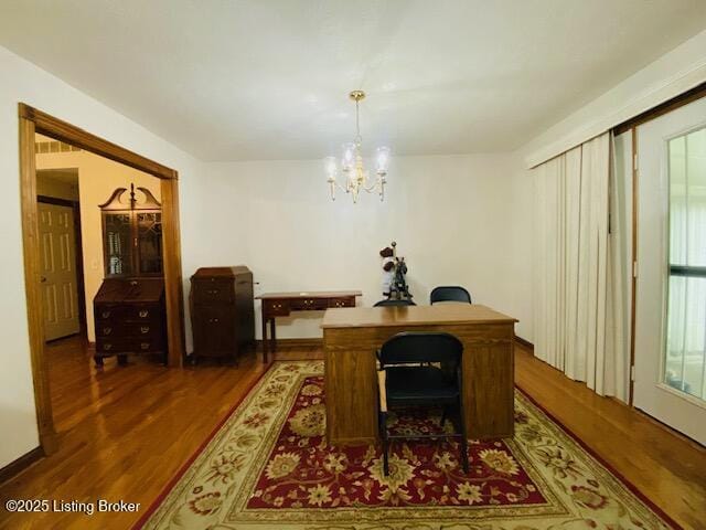office area with wood finished floors and a chandelier