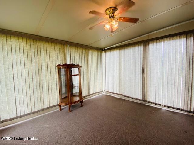 empty room featuring ceiling fan and carpet flooring