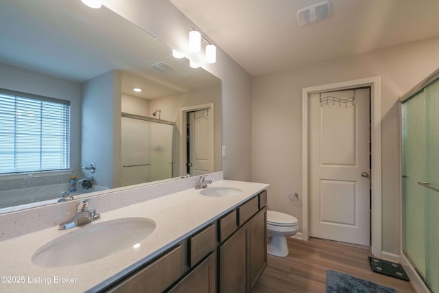 11905 Parkside Vista Ln, Louisville, KY 40229 - full bathroom featuring a shower stall, wood finished floors, double vanity, toilet, and baseboards