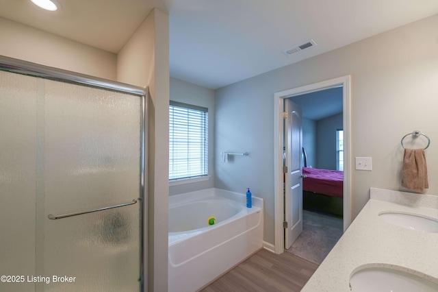 11905 Parkside Vista Ln, Louisville, KY 40229 - bathroom with wood finished floors, healthy amount of natural light, a bath, and a stall shower