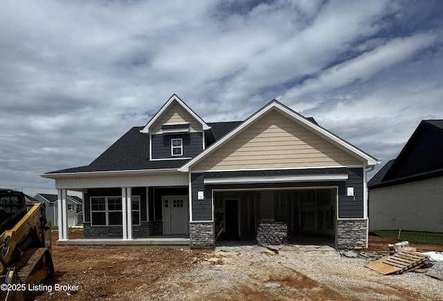 309 Ashwood Ave, Elizabethtown, KY 42701 - craftsman inspired home featuring stone siding, a garage, covered porch, and dirt driveway