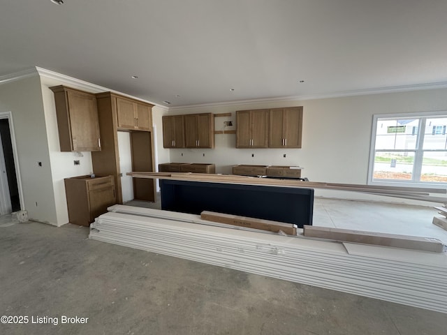 309 Ashwood Ave, Elizabethtown, KY 42701 - kitchen featuring ornamental molding, a kitchen island, concrete floors, and brown cabinetry