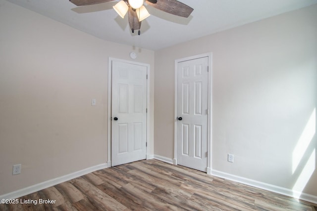 522 Lee Rd, Elizabethtown, KY 42701 - unfurnished bedroom with wood finished floors, baseboards, and ceiling fan
