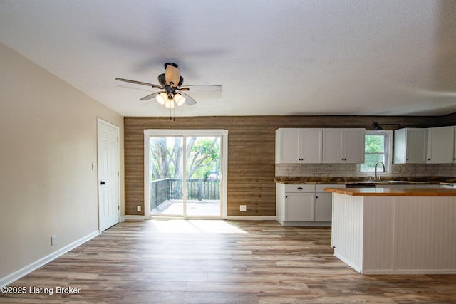 522 Lee Rd, Elizabethtown, KY 42701 - kitchen with light wood-style flooring, ceiling fan, white cabinetry, baseboards, and a sink