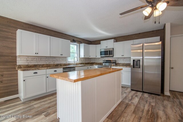 522 Lee Rd, Elizabethtown, KY 42701 - kitchen with appliances with stainless steel finishes, wood counters, white cabinetry, light wood finished floors, and decorative backsplash
