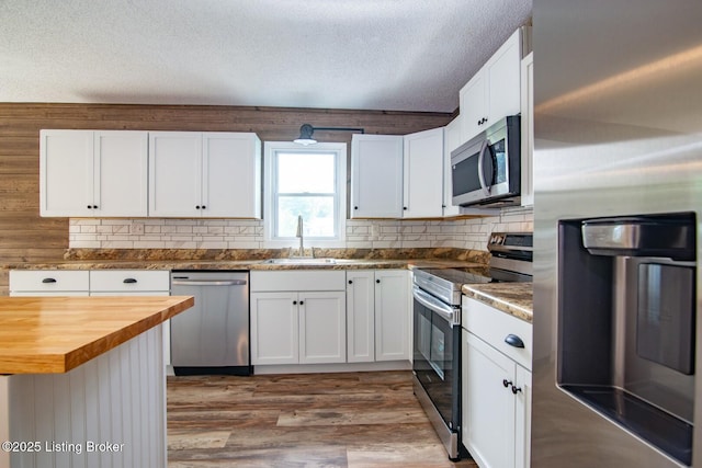 522 Lee Rd, Elizabethtown, KY 42701 - kitchen featuring appliances with stainless steel finishes, wood counters, a sink, a textured ceiling, and white cabinets