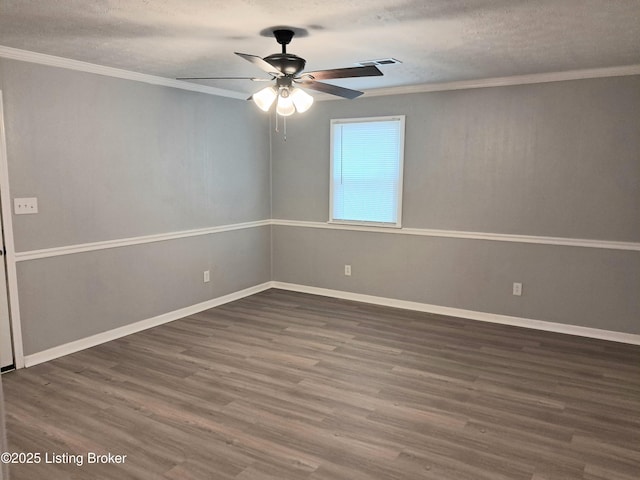 spare room featuring ceiling fan, wood finished floors, baseboards, ornamental molding, and a textured ceiling