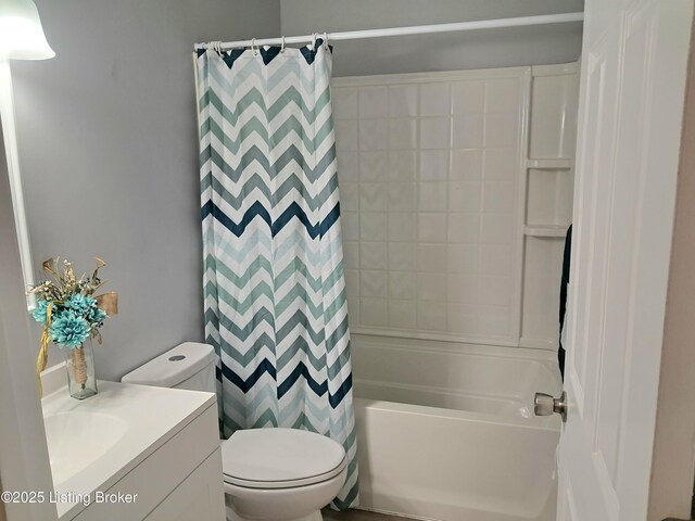 bathroom featuring toilet, vanity, and shower / bath combination with curtain