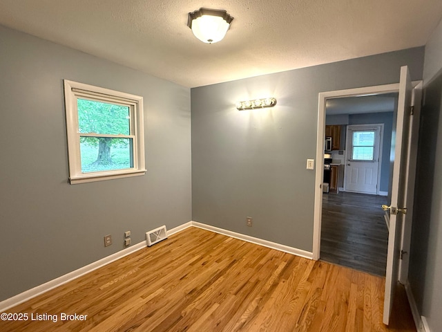701 Dogwood Dr, Elizabethtown, KY 42701 - spare room featuring wood finished floors, baseboards, and a textured ceiling