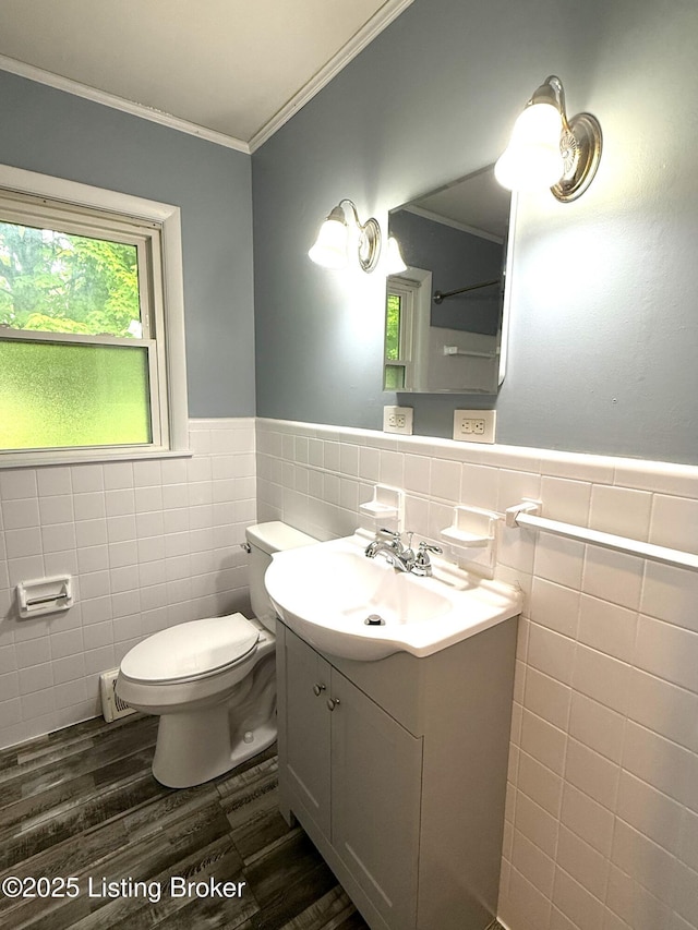 701 Dogwood Dr, Elizabethtown, KY 42701 - bathroom with tile walls, toilet, wood finished floors, ornamental molding, and a wainscoted wall