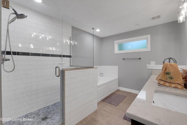 361 Williamsburg Dr, Mt Washington, KY 40047 - bathroom featuring a shower stall, double vanity, a garden tub, and baseboards