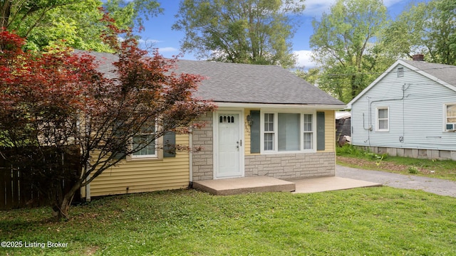 7802 Edna M Rd, Louisville, KY 40258 - view of front of property featuring stone siding, a shingled roof, and a front yard