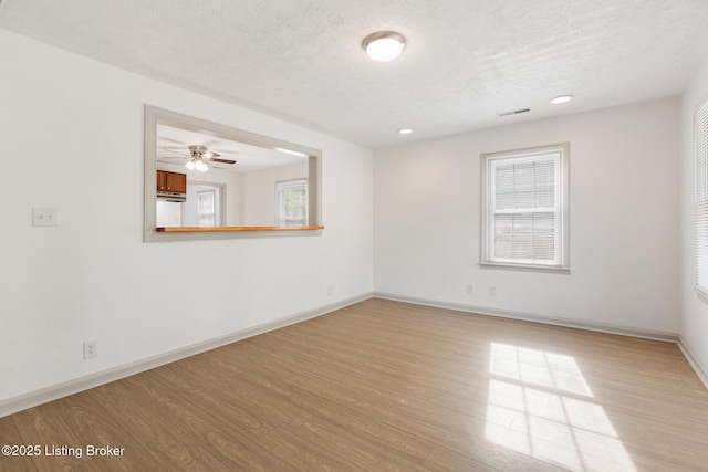 7802 Edna M Rd, Louisville, KY 40258 - empty room with wood finished floors, a textured ceiling, baseboards, recessed lighting, and ceiling fan