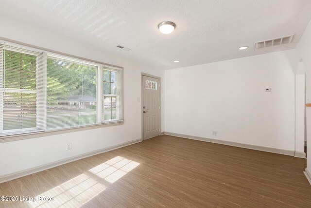 7802 Edna M Rd, Louisville, KY 40258 - unfurnished room with wood finished floors, baseboards, recessed lighting, and a textured ceiling