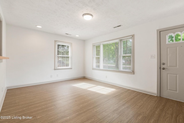 7802 Edna M Rd, Louisville, KY 40258 - entrance foyer featuring wood finished floors, a textured ceiling, baseboards, and recessed lighting