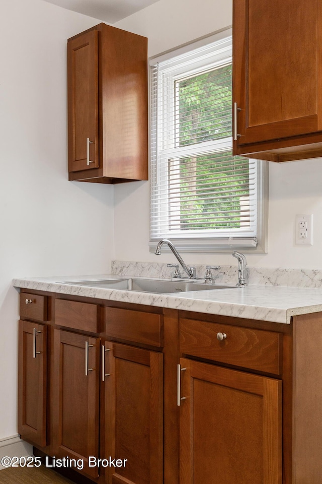 7802 Edna M Rd, Louisville, KY 40258 - kitchen featuring a sink, brown cabinets, and light stone counters