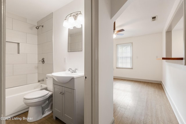 7802 Edna M Rd, Louisville, KY 40258 - full bathroom with ceiling fan, toilet, wood finished floors, vanity, and shower / washtub combination