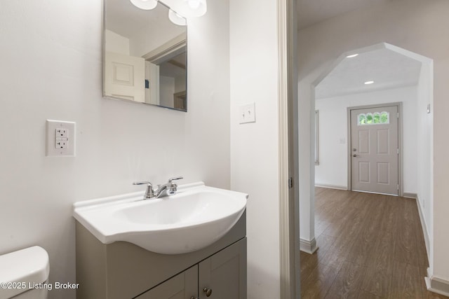 7802 Edna M Rd, Louisville, KY 40258 - bathroom featuring wood finished floors, toilet, vanity, and baseboards