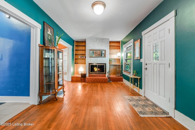 1830 Edgeland Ave, Louisville, KY 40204 - foyer with a fireplace, wood finished floors, and baseboards